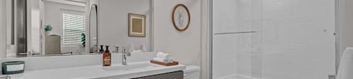 a bathroom with a shower and a sink and a toiletat Westbury Apartments, Rancho Cucamonga, California