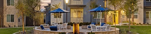 a courtyard with tables and chairs in front of an apartment buildingat Westbury Apartments, Rancho Cucamonga, CA