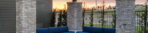 a patio with blue couches and a fire pitat Westbury Apartments, Rancho Cucamonga, California