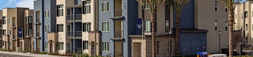 a street view of an apartment building with palm treesat Westbury Apartments, Rancho Cucamonga, California