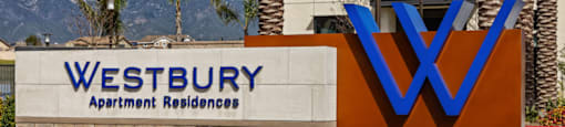 a sign for westbury apartment buildings with mountains in the backgroundat Westbury Apartments, Rancho Cucamonga, CA, 91739
