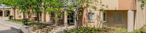 a building with trees and a sidewalk in front of it at International Village UCR Student Housing, Riverside, 92507