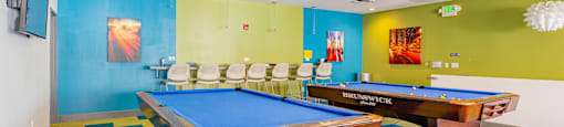 a game room with two pool tables and a television at International Village UCR Student Housing, California, 92507