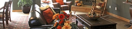 a community room filled with furniture and a fire place