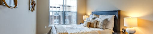 a bedroom with a large bed and a window