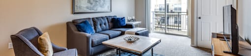 a living room with a couch and chair and a television