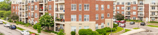 an aerial view of an apartment building with cars parked in front of it