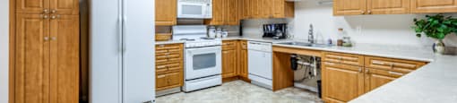 a kitchen with white appliances and wooden cabinets