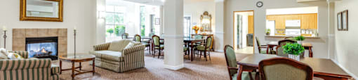 community room with a fireplace and a dining table