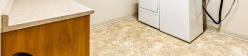 a laundry room with a washer and dryer in it and a counter top