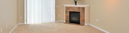 a living room with a fireplace and a window