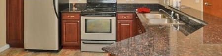 a kitchen with a stove a refrigerator and a sink