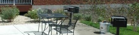 a patio with a table and chairs