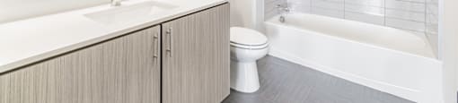 Bathrooms featuring quartz countertops extra storage and space at Pinnacle Heights Apartments at Rogers, Arkansas.