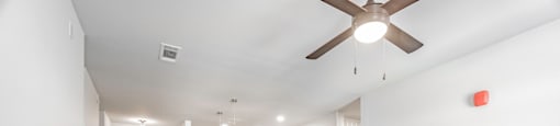 One and two Bedroom Apartment Homes with Large Kitchens with ample storage and light cabinets, quarts countertops and stainless steel appliances at Pinnacle Heights Apartments in Rogers, Arkansas