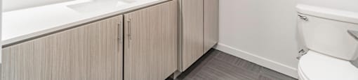 Bathrooms featuring quartz countertops extra storage and space at Pinnacle Heights Apartments at Rogers, Arkansas.