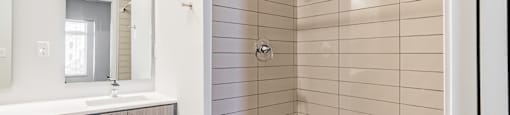 Bathrooms featuring quartz countertops extra storage and space at Pinnacle Heights Apartments at Rogers, Arkansas.