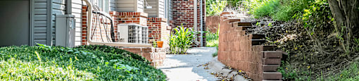 Beautiful walkway with plants  at Deer Park Apartments in Council Bluffs, IA