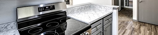 Kitchen with stainless steel appliances  at Deer Park Apartments in Council Bluffs, IA