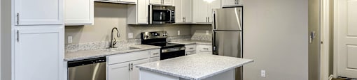 Large kitchen with white cabinets and stainless steel appliances at Legacy Commons, Omaha, NE, 68130
