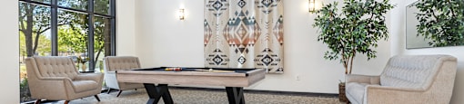 Modern clubhouse featuring community lounge, coffee bar, salon and spa, billiards and poker room, and concierge package room at Parkside Apartments and Shops in Bentonville, AR