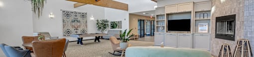 Modern clubhouse featuring community lounge, coffee bar, salon and spa, billiards and poker room, and concierge package room at Parkside Apartments and Shops in Bentonville, AR