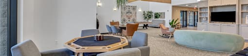 Modern clubhouse featuring community lounge, coffee bar, salon and spa, billiards and poker room, and concierge package room at Parkside Apartments and Shops in Bentonville, AR