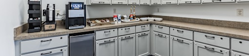 Modern clubhouse featuring community lounge, coffee bar, salon and spa, billiards and poker room, and concierge package room at Parkside Apartments and Shops in Bentonville, AR