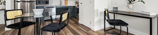 Upscale studio, one, and two-bedroom apartment homes featuring two-tone kitchen cabinetry, quartz countertops, stainless steel appliances, luxury vinyl wood flooring, and much more at Parkside Apartments and Shops in Bentonville, AR