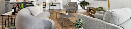Upscale studio, one, and two-bedroom apartment homes featuring two-tone kitchen cabinetry, quartz countertops, stainless steel appliances, luxury vinyl wood flooring, and much more at Parkside Apartments and Shops in Bentonville, AR