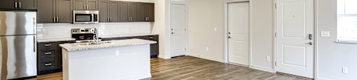 an open kitchen and living room with wood flooring at Sandstone Villas Apartments, Omaha, 68116