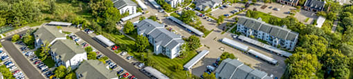 an aerial view of a neighborhood with houses and trees