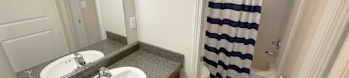 a bathroom with a sink and a shower and a curtain
