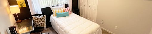 a small bedroom with a bed and a window