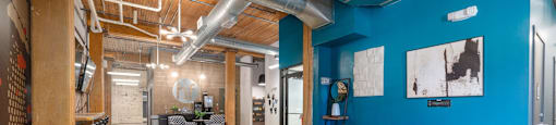 a large room with blue walls and a wooden table in the middle of the room