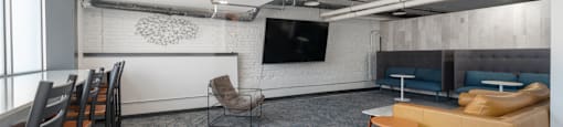 a room with a couch chairs and a table