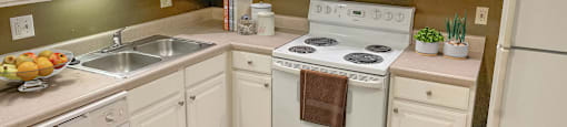 a kitchen with white appliances and white cabinets