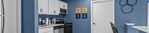 a blue and white kitchen and dining room with a table and chairs