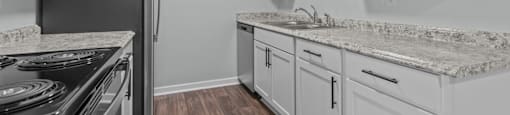 the kitchen in a new home with white cabinets and stainless steel appliances