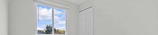 A room with a window and a door.