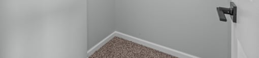 an empty room with white walls and a door