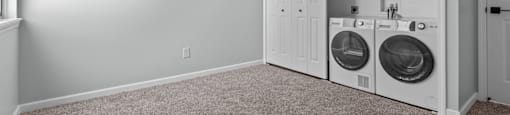 a washer and dryer in a laundry room with a door to the closet