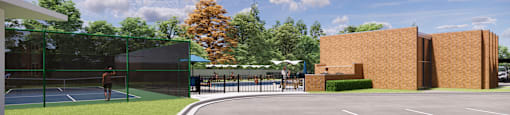 A man is playing tennis on a court with a green fence and a building in the background.