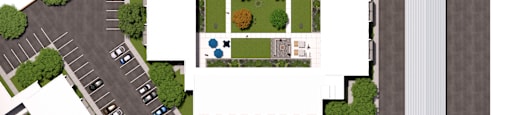 A bird's eye view of a parking lot with a building in the middle.