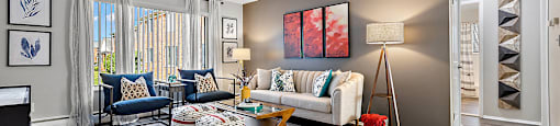 spacious living room with wood flooring and windows at the reserve apartments