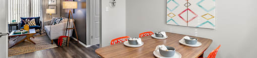 a dining room with a wooden table and chairs and a ceiling fan