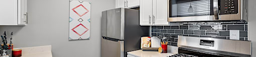 a kitchen with stainless steel appliances and a stainless steel microwave