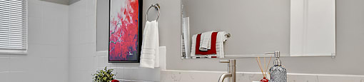 a bathroom with white cabinets and a toilet and a sink