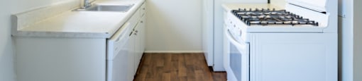 a small kitchen with white appliances and white cabinets