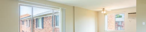 the living room of an empty house with large windows